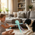 Girl and dog playing tug of war with teal crochet octopus toy